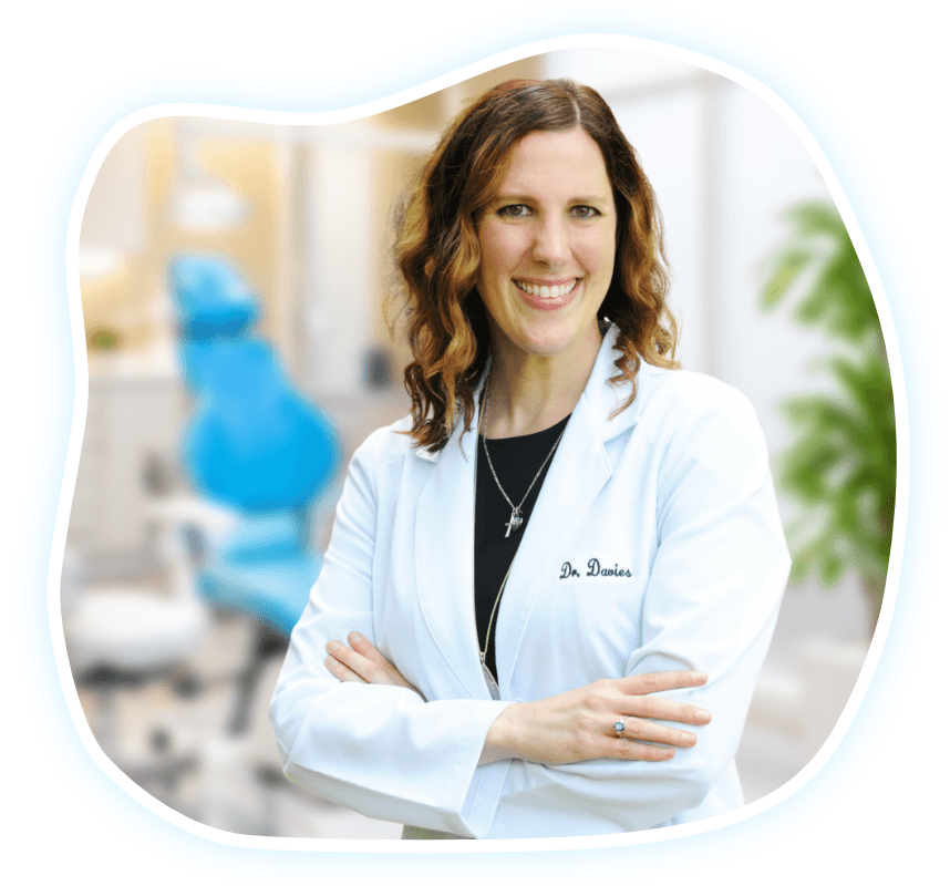 Photo of Dr. Jenna Davies with a badge that reads 'Jenna Davies DDS'